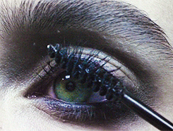 Close up video clip of woman applying mascara to finish her eye makeup