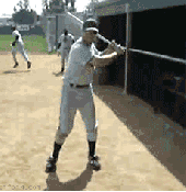 Batter warming up in the bullpen doing a little tricky spin of the bat