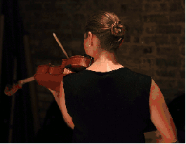 Animation of girl in black dress playing violin facing away with her back toward you