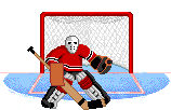 Hockey goalie in red jersey, mask and protective gear defending the net from the opposing team