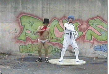 Moving animated picture of two interesting dancers on the street in weird attire