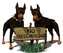 Two bad dogs waiting to eat you if you don't head the warning sign, No Trespassing