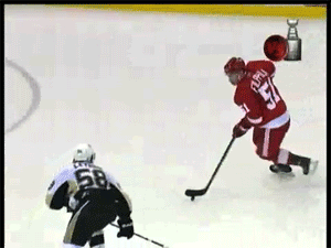 This hockey player has to work for this goal with just a few obstacles in the way to be avoided