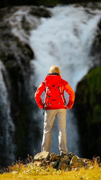 Photorealistic view of a girl watching a waterfall looping animated gif