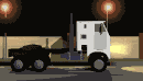 Truck driving along the road past street lights