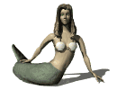 Mermaid gives a little wiggle of her tail sitting on the beach