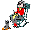 woman in rocking chair knitting with cat